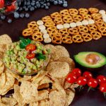 Snacks and with chips and salsa out for american super bowl watching party top view